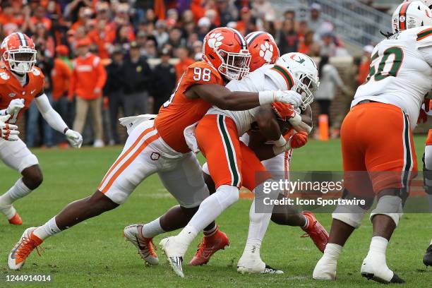 Clemson Tigers defensive end Myles Murphy tackles Miami Hurricanes running back Jaylan Knighton during a college football game between the Miami...