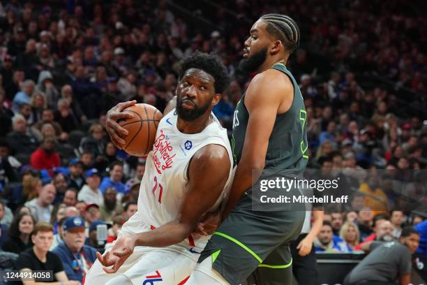 Joel Embiid of the Philadelphia 76ers drives to the basket against Karl-Anthony Towns of the Minnesota Timberwolves in the first half at the Wells...