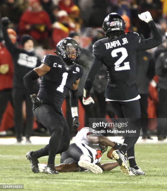 Defensive backs Anthony Johnson Jr. #1 and T.J. Tampa of the Iowa State Cyclones celebrate a stop during the first half against SaRodorick Thompson...