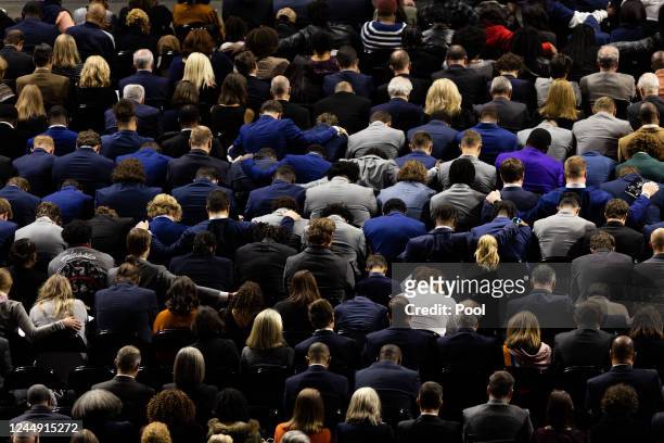 University of Virginia football players bow their heads in prayer during a memorial service for three slain University of Virginia football players...