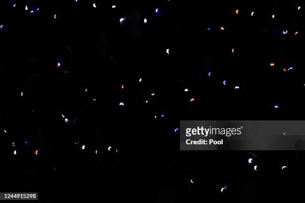 Wristbands light up during a moment of reflection during a memorial service for three slain University of Virginia football players Lavel Davis Jr.,...