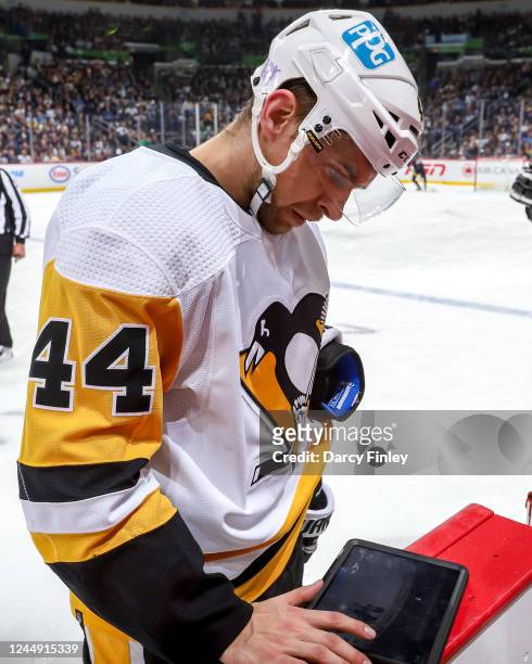Jan Rutta of the Pittsburgh Penguins reviews the play on an iPad during a second period stoppage in play against the Winnipeg Jets at the Canada Life...