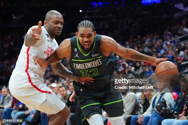 Karl-Anthony Towns of the Minnesota Timberwolves drives to the basket against P.J. Tucker of the Philadelphia 76ers in the second half at the Wells...
