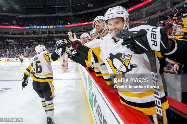 Jason Zucker of the Pittsburgh Penguins celebrates his third period goal against the Winnipeg Jets with teammates at the bench at the Canada Life...