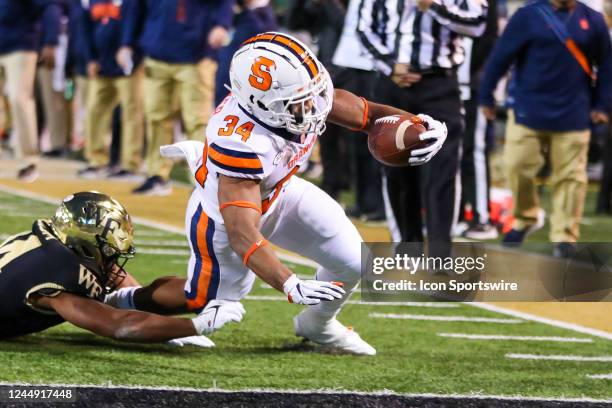 Sean Tucker of the Syracuse Orange dives for the end zone as he runs the ball during a football game between the Wake Forest Demon Deacons and the...