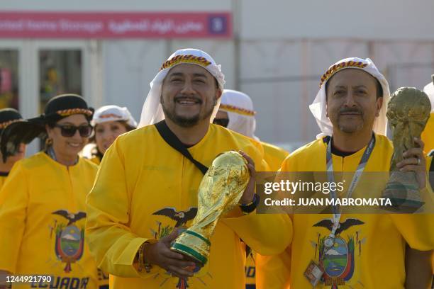 Fans of Ecuador display fake World Cup trophies as they arrive at the Al-Bayt Stadium in Al Khor, north of Doha, on November 20 before the kick-off...