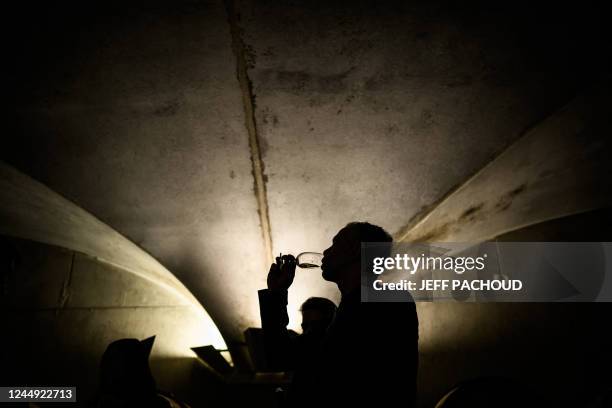 Person tastes the wines that will be sold during 162nd edition of the "Hospices de Beaune" charity auction wine sale in Beaune, central France, on...