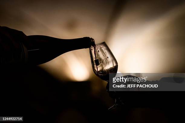 Person serves a glass of the wines that will be sold during 162nd edition of the "Hospices de Beaune" charity auction wine sale in Beaune, central...