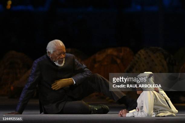Actor Morgan Freeman and Qatari YouTuber Ghanim al-Muftah speak during the opening ceremony of the Qatar 2022 World Cup Group A football match...