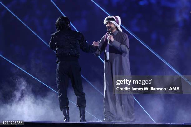 South Korean pop star Jung Kook of BTS greets Qatari singer Fahad Al-Kubaisi on stage during the opening ceremony of the FIFA World Cup Qatar 2022...