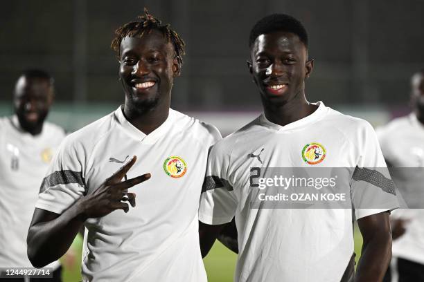 Senegal's forward Famara Diedhiou and Senegal's defender Formose Mendy pose during a training session at Al Thumama stadium in Doha on November 20 on...