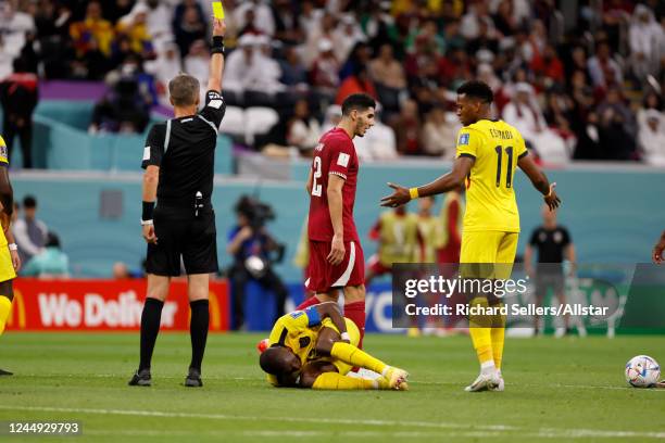 Referee Daniele Orsato books Ro-Ro of Qatar during the FIFA World Cup Qatar 2022 Group A match between Qatar and Ecuador at Al Bayt Stadium on...