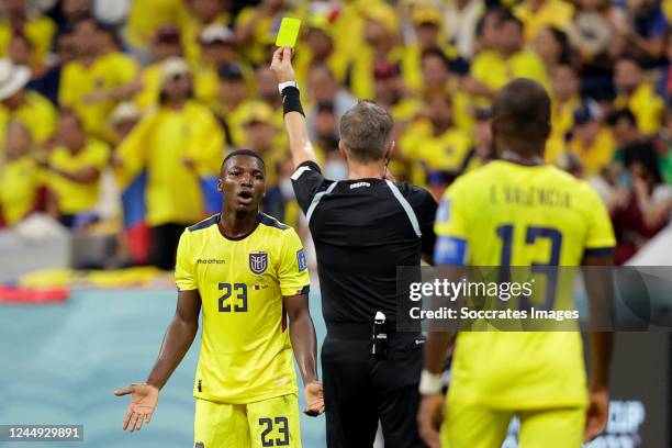 Moises Caicedo of Ecuador receives a yellow card from referee Daniele Orsato during the World Cup match between Qatar v Ecuador at the Al Bayt...