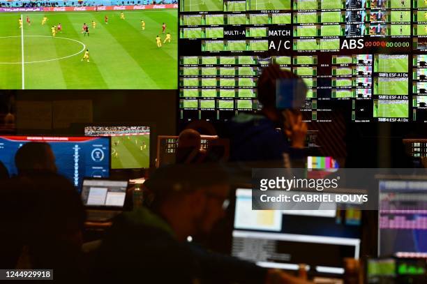 People work in a control room at the International Broadcast Center in Doha on November 20 during the Qatar 2022 FIFA World Cup Group A football...