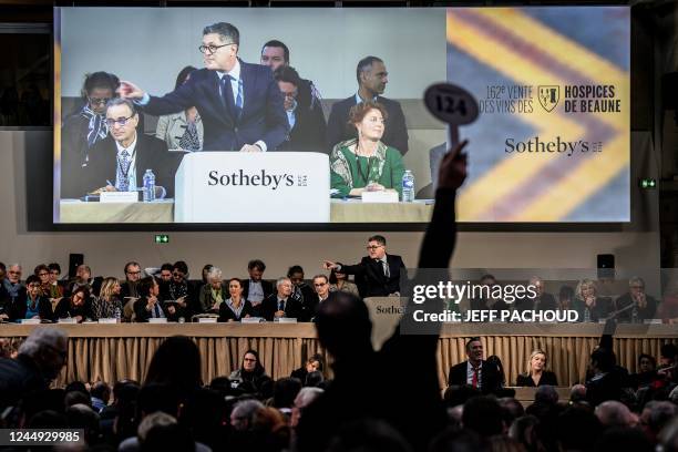 An auctioneer supervises the Hospices de Beaune 162nd charity wine auction in Beaune, on November 20 central France. - The « Piece des Presidents »...