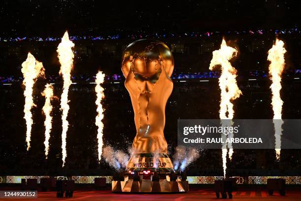 Fireworks explode around a replica of the FIFA World Cup trophy during the opening ceremony ahead of the Qatar 2022 World Cup Group A football match...