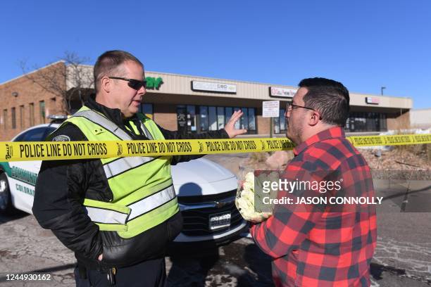 Colorado Springs Community Service officer speaks with Jace Khosla, of Pueblo, Colorado, the morning after a mass shooting at Club Q, an LGBTQ...