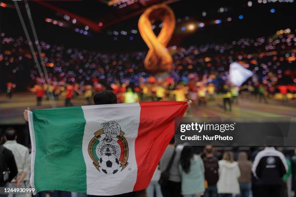 Woman holds a Mexican flag during the FIFA Fan Festival Mexico Corona on the esplanade of the Monument to the Revolution in Mexico City, on the...