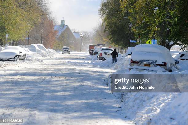 Buffalo, NY Cars make their way through tree lined streets after an intense lake-effect snowstorm that impacted the area on November 20, 2022 in...