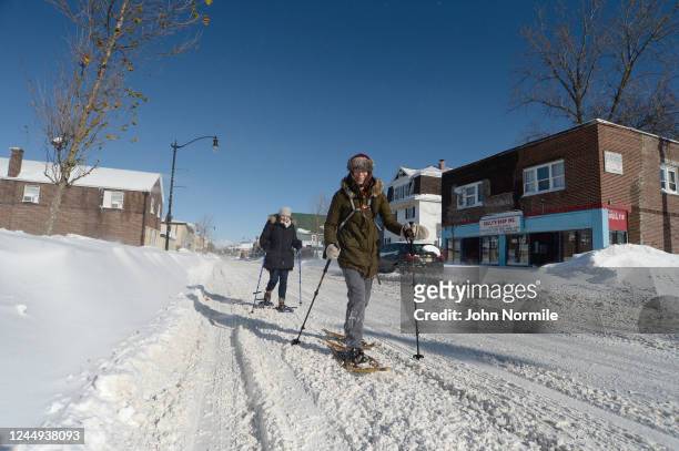 Buffalo, NY Megan Barr and Amanda Johnston snowshoe through snow covered streets after an intense lake-effect snowstorm that impacted the area on...