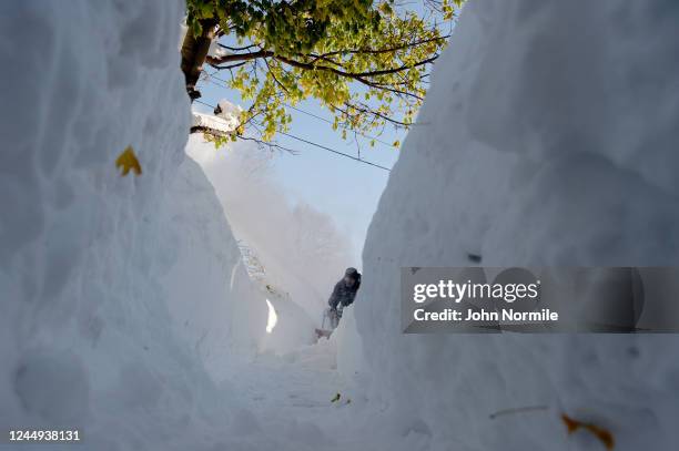 Buffalo, NY Frank Barillo clears his sidewalk after an intense lake-effect snowstorm that impacted the area on November 20, 2022 in Buffalo, New...