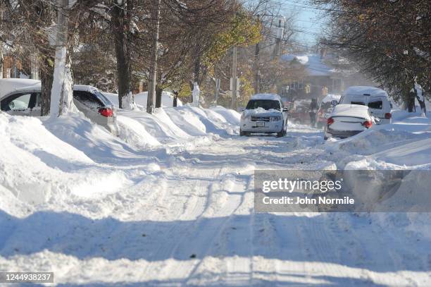 Buffalo, NY Cars make their way through tree lined streets after an intense lake-effect snowstorm that impacted the area on November 20, 2022 in...