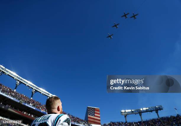 Johnny Hekker of the Carolina Panthers watches a military flyover prior to an NFL football game against the Baltimore Ravens at M&T Bank Stadium on...