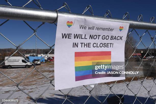 Sign hangs from a fence near Club Q, an LGBTQ nightclub, in Colorado Springs, Colorado, on November 20, 2022. At least five people were killed and 18...