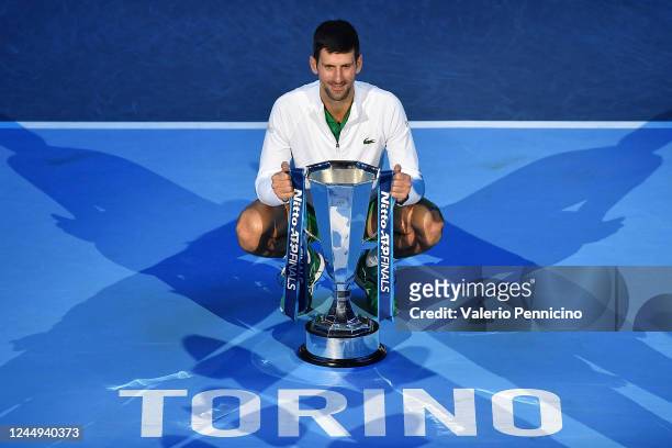 Novak Djokovic of Serbia celebrates with the winners trophy after his win over Casper Ruud of Norway during day eight of the Nitto ATP Finals at Pala...