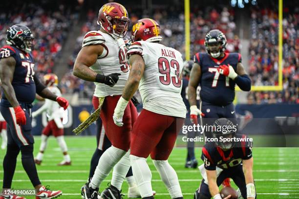 Washington Commanders defensive tackle Jonathan Allen celebrates a second half sack with Washington Commanders defensive tackle Daron Payne during...