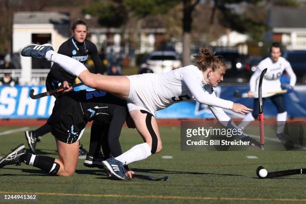 Middlebury College Panthers Amy Griffin is tripped up while stick handling against the Johns Hopkins Blue Jays during the Division III Womens Field...
