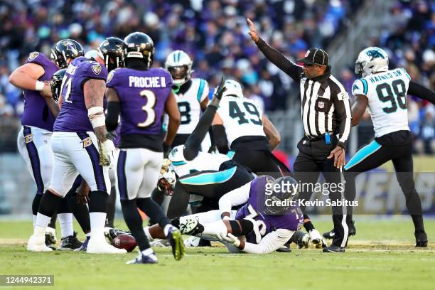 Ronnie Stanley of the Baltimore Ravens holds his knee while laying on the ground injured after a play during the third quarter of an NFL football...