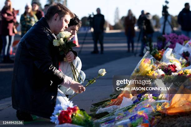 Ren Kurgis and Jessie Pacheco pay their respects to the victims of the mass shooting at Club Q, an LGBTQ nightclub, in Colorado Springs, Colorado, on...