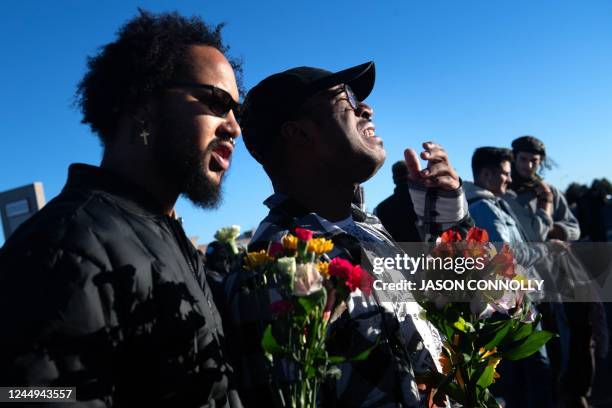 Je-Zeravon Swisher cries as he stands next to his partner Jonathon Willis while paying their respects to the victims of the mass shooting at Club Q,...