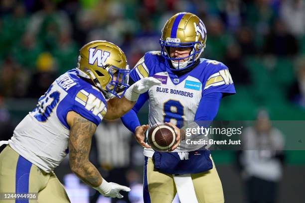 Zach Collaros hands the ball off to Brady Oliveira of the Winnipeg Blue Bombers in the first half of the 109th Grey Cup game between the Toronto...