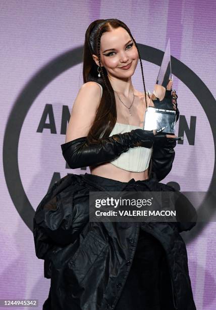 Singer Dove Cameron poses with the trophy for New Artist of the Year in the press room during the 50th Annual American Music Awards at the Microsoft...