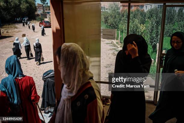 Women and girls leave a tutoring center in Bamyan, Afghanistan, Monday, Sept. 5, 2022. A year after the precipitous fall of the U.S.-backed republic...