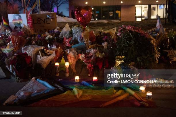 Flower bouquets, candles, and other items form a memorial near the LGBTQ nightclub, Club Q, in Colorado Springs, Colorado on November 20, 2022. - At...