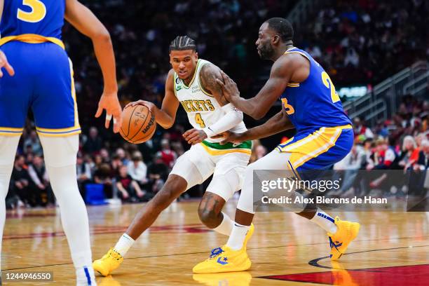 Jalen Green of the Houston Rockets dribbles the ball against Draymond Green of the Golden State Warriors during the second quarter of the game at...