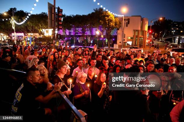 People gather to attend a candlelight vigil along Santa Monica Blvd. In front of Roccos on Sunday, Nov. 20, 2022 in Los Angeles, CA. City leaders and...