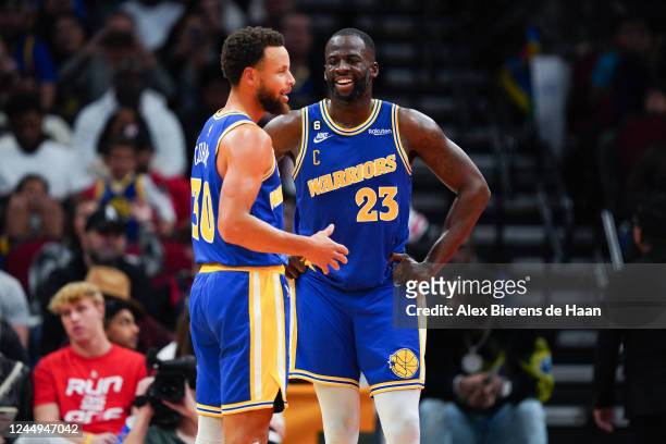Stephen Curry of the Golden State Warriors and Draymond Green of the Golden State Warriors talk during a timeout in the fourth quarter of the game...