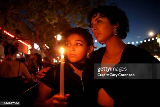 Jacky Santiago left, and Khayra , Mentado both of Los Angeles, attend a candlelight vigil along Santa Monica Blvd. In front of Roccos on Sunday, Nov....