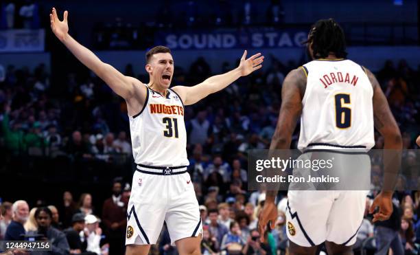 Vlatko Cancar of the Denver Nuggets celebrates with teammate DeAndre Jordan after making a long range three point basket against the Dallas Mavericks...