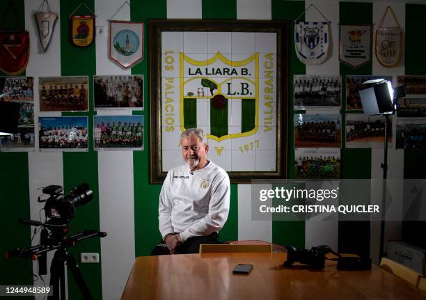 Spanish coach Manuel Basco poses for a photograph in the trophies room at La Liara Balompie club's in Los Palacios y Villafranca, south of Seville on...