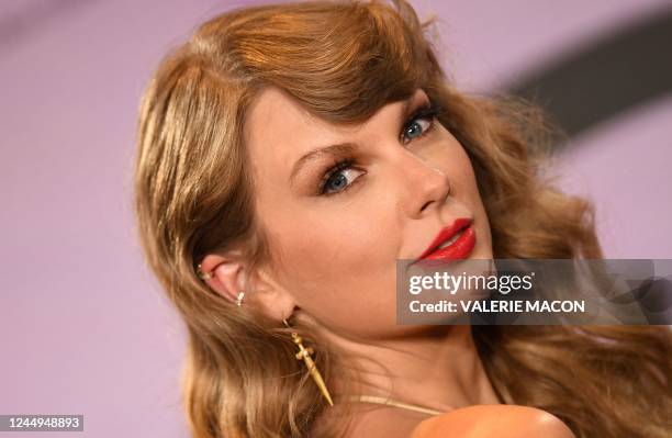 Singer Taylor Swift poses in the press room after winning six awards at the 50th Annual American Music Awards at the Microsoft Theater in Los...