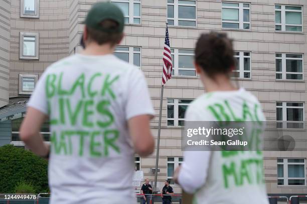 Demonstrators protesting over the death of George Floyd and wearing Black Lives Matter shirts stand outside the U.S. Embassy during a small protest...
