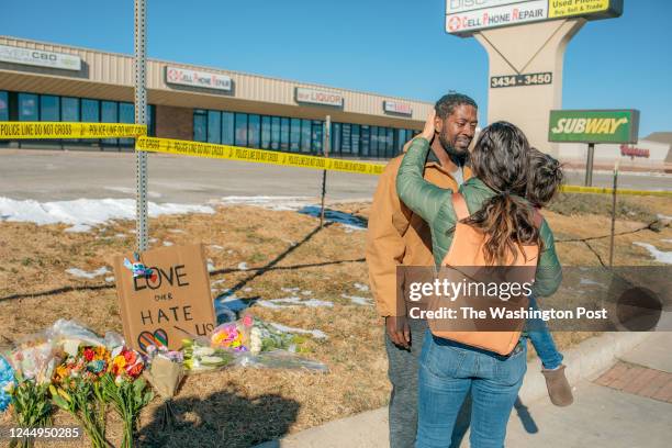Kara Too and her children hug Joshua Thurman after Kara and family placed flowers at the police tape for a growing memorial related to the shooting...