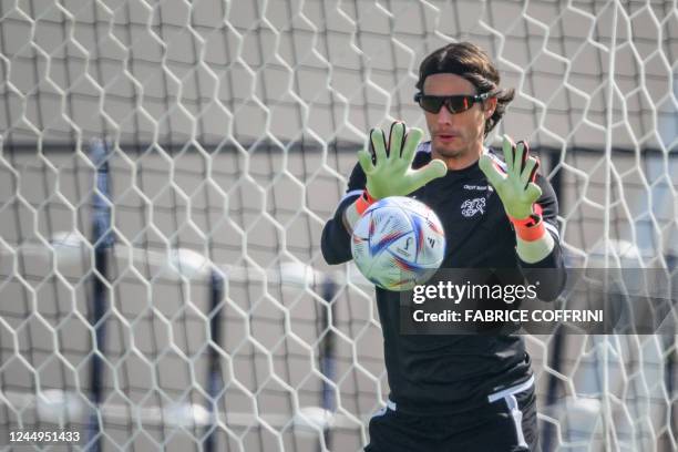 Switzerland's goalkeeper Yann Sommer, wearing special darker glasses, takes part in a training session at the University of Doha for Science and...