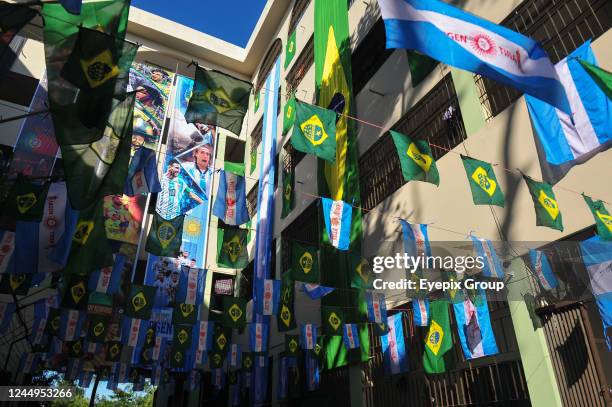 Students from Jalalabad Ragib-Rabeya Medical College & Hospital hang team flags and banners on their accommodation building during the FIFA World Cup...