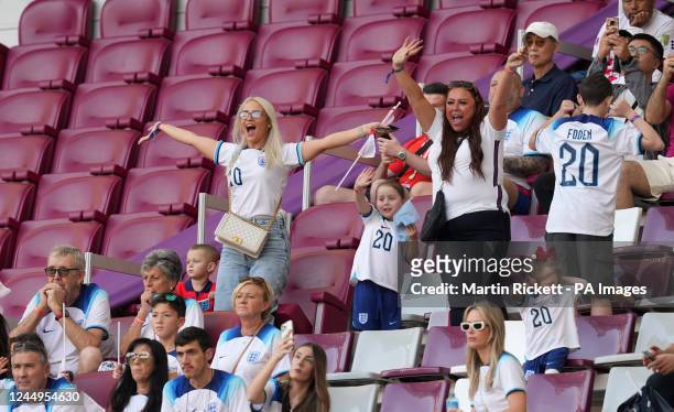 Rebecca Cooke, girlfriend of England's Phil Foden, with son Ronnie Foden in the stands before the FIFA World Cup Group B match at the Khalifa...